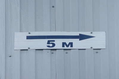 Close-up of information sign on wall