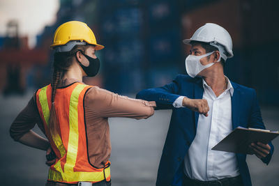 Midsection of man working with mobile phone