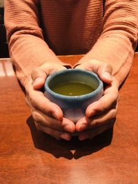 Close-up of human hand holding tea cup