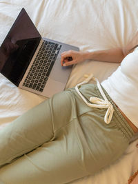 Midsection of woman using laptop