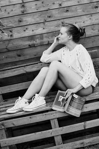 Woman drinking water from bench