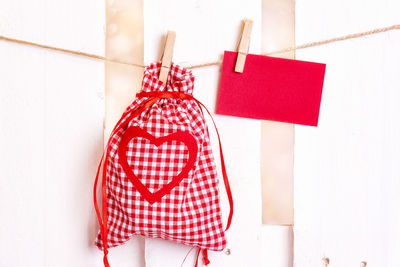 Close-up of sack and paper hanging on clothesline