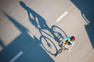 High angle view of woman riding bicycle on street