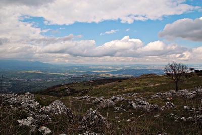 Scenic view of landscape against cloudy sky