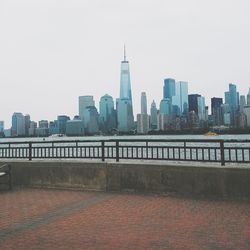 View of city buildings against clear sky