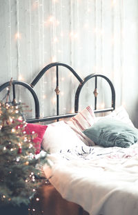 Close-up of bed with christmas tree