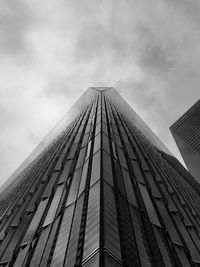 Low angle view of one world trade center against cloudy sky at manhattan in city