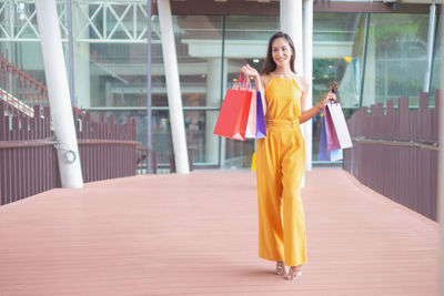 Full length of woman standing against the wall