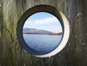 Scenic view of sea seen through hole