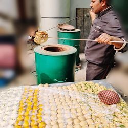 Side view of man working with food