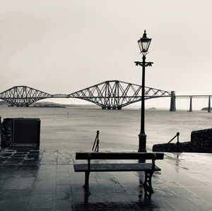 Street lights next to sea looking over bridge 