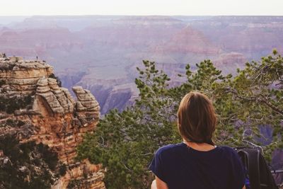 Rear view of woman looking at canyon