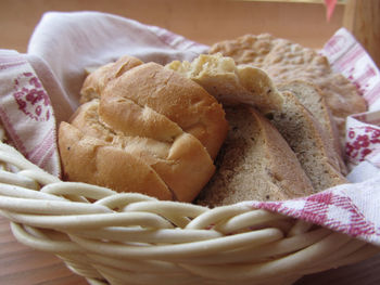 Assortment of baked bread and bun in a wicker basket