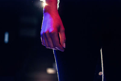 Cropped image of woman standing at night