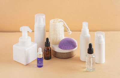 Beauty, spa and wellness concept. facial cosmetic products, konjac sponge on a beige background. 