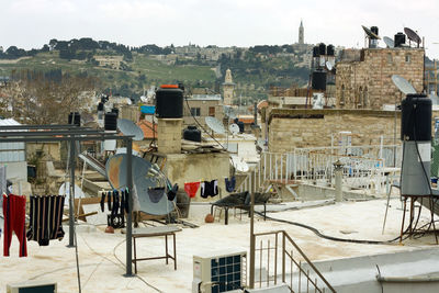 Clothesline and satellite dish on building terrace in town