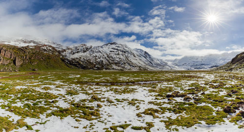 Scenic view of snow covered mountains against sky