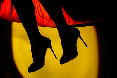 Low section of person wearing red shoes