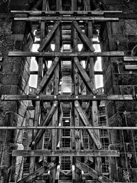 Low angle view of bridge against buildings