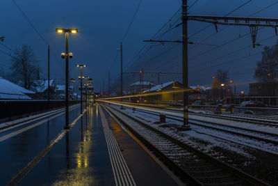 Railroad tracks against sky during sunset