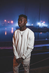 Full length of young man looking away at night