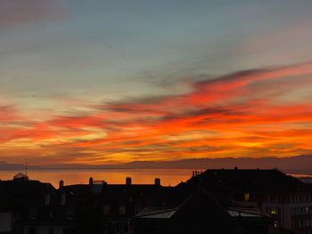 Silhouette buildings against sky during sunset