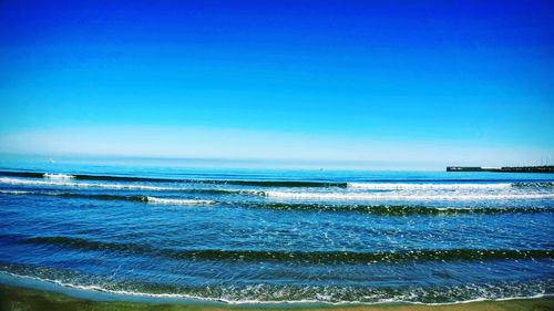 Scenic view of sea against clear blue sky