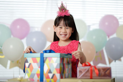 Portrait of a smiling girl with balloons