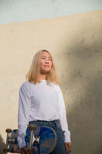 A young woman with a skateboard