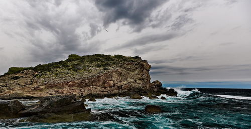 Scenic view of sea against cloudy sky