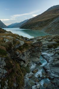 Scenic view of lake and mountains against sky