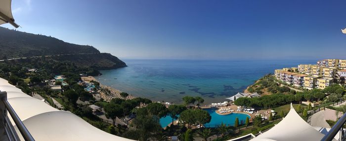 High angle view of swimming pool by sea against clear sky