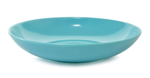 Close-up of blue bowl over white background