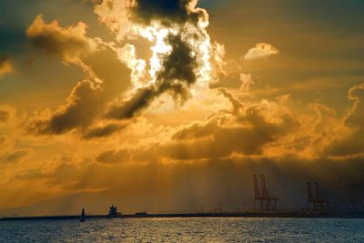 Boats sailing in sea against sky during sunset