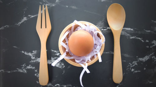 Closeup egg with wooden spoon on table, top view egg, ingredients cooking concept,