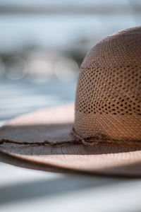 Close-up of hat on table by sea