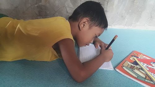 Boy playing on bed