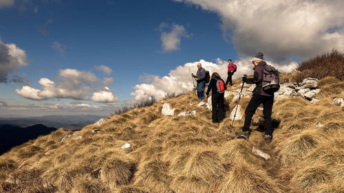 Small group of senior hikers on the mountain ridge