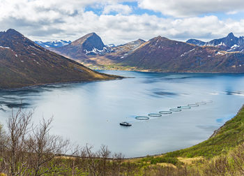 Scenic view of lake and mountains against sky