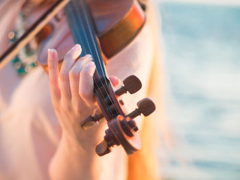 Close-up of hand playing violin