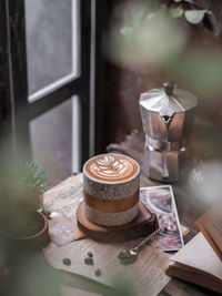 Close-up of coffee on table beside the window