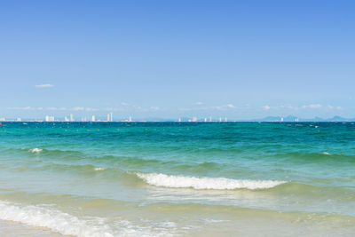 Scenic view of beach against blue sky