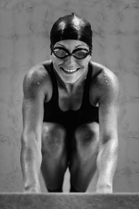 Portrait of smiling woman in swimwear at poolside