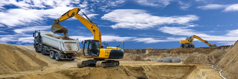 Construction site by road against sky