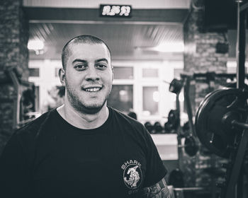 Portrait of young man standing in gym