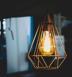 Low angle view of illuminated lamp against sky at night