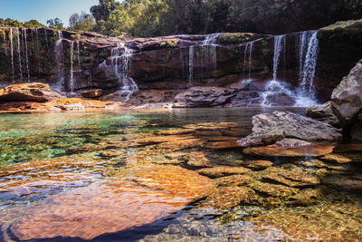 Natural waterfall white water streams with calm clear water at morning