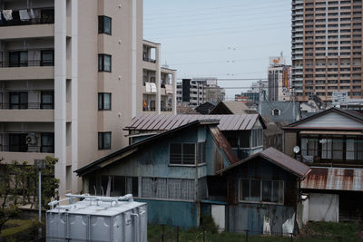 Houses in city against clear sky