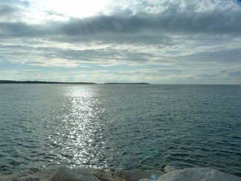 Scenic view of sea against cloudy sky