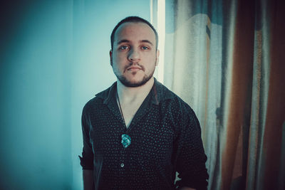 Portrait of young man against wall